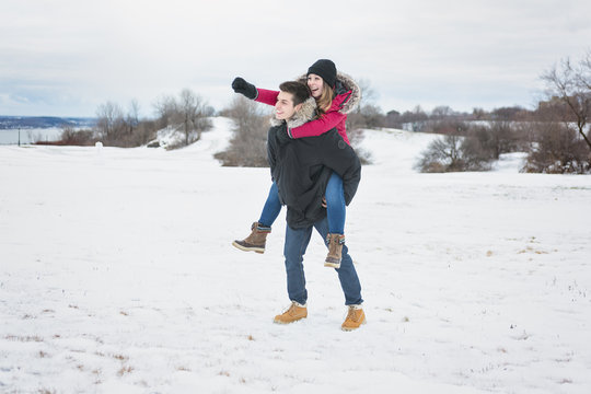 Two teenagers havinf fun on the snow field