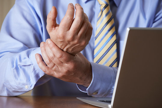 Businessman Suffering From Repetitive Strain Injury (RSI)