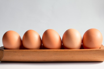 Egg in a wooden tray white background