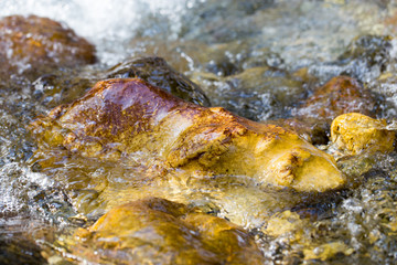 colored stones under water as background