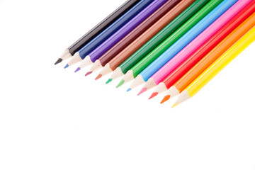 Many colorful pencil like a rainbow on diagonal line, isolated white.