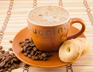 cup of cappuccino and cookies