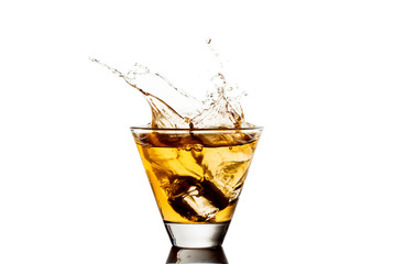 Glass of whiskey with splash, isolated on white background