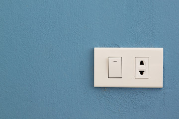 Electricity switch and plug on concrete wall