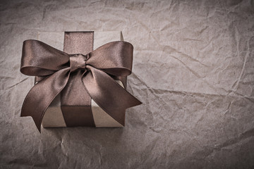 Birthday present with brown bow on wrapping paper holidays conce