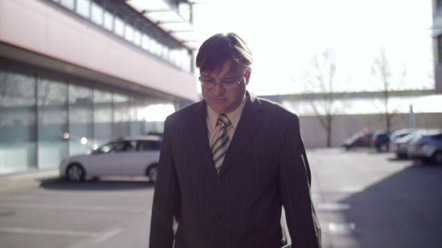 Slow motion of a sad business man walking relieved