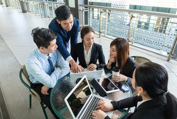 Group of business people project planning at outdoor cafe © leungchopan