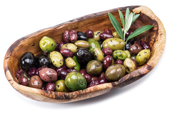 Whole table olives in the wooden bowl on the white background.