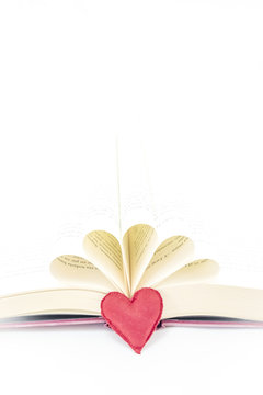 open book and a red heart next to the book
