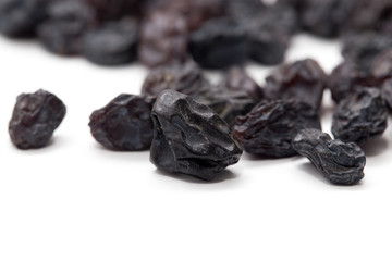 Black raisins on a white background. macro