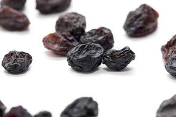 Black raisins on a white background. macro