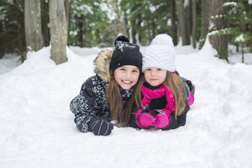 Fototapeta na wymiar Two girls looking at camera in winter park