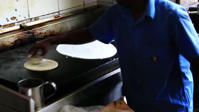 Locked-on shot of chefs preparing dosa, Chennai, Tamil Nadu, India