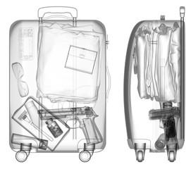 Suitcase with handgun under xray on security control black and white