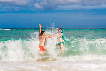 Happy couple having fun on the beach of a tropical island. Summe