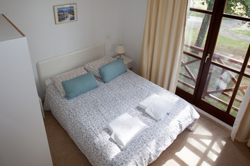 Double Bed In The Bedroom With Desk Lamp Near It