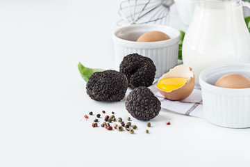 Black truffles with eggs and milk. Close- up.