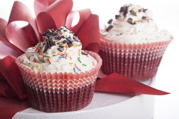 Cupcakes   on background red bow.