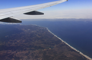 Obraz premium Aerial view of the California with an airplane wing