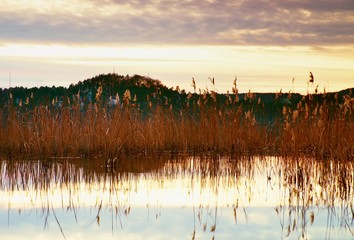 Beautiful autumn sunrise or sunset with Reflection on Lake water level. Gentle waves