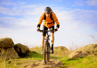 Cyclist Riding the Bike on Morning Mountain Trail