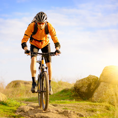Fototapeta premium Cyclist Riding the Bike on Morning Mountain Trail
