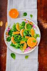 Fresh salad of lamb's lettuce and mandarins on plate