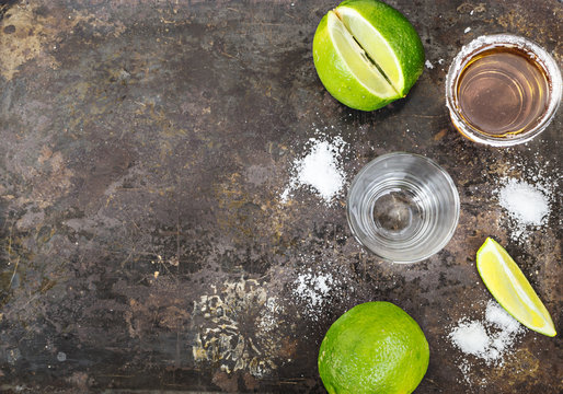 Tequila shots with lime slice, top view