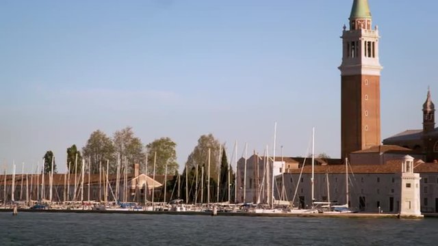 Panning shot of the marina and cathedral at the Island of San Giorgio.