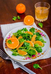 Fresh salad of lamb's lettuce and mandarins on plate