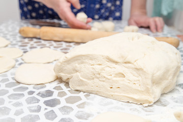 sheeting the dough with a rolling pin in the kitchen