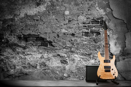 Electric guitar on a brick wall background © George Dolgikh