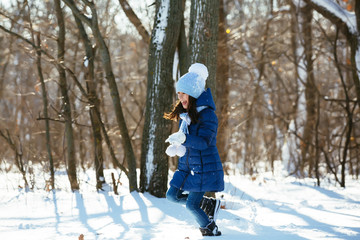 Fototapeta na wymiar Little girl outdoors on beautiful winter snow day