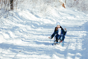 Fototapeta na wymiar Little girl on sleigh