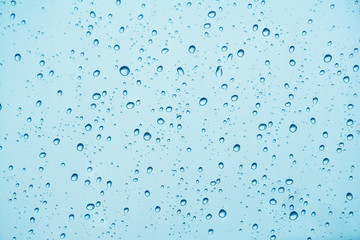 Water drop on blue glass.