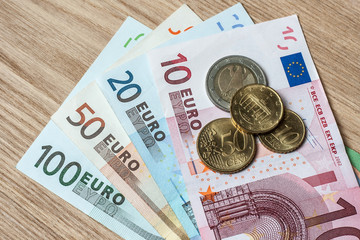euro banknotes coin wood table