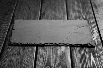 Black slateboard on dark wood