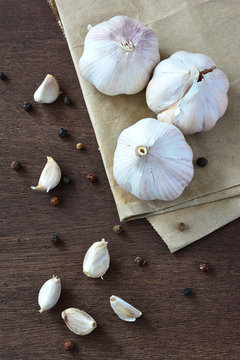 Garlic on brown wooden background.