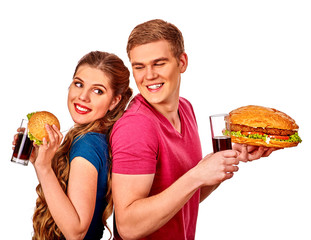 Back to back man and woman eating hamburgers and coca cola . Fastfood concept. Isolated.