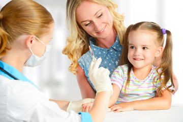 Doctor  pediatrician makes child vaccination