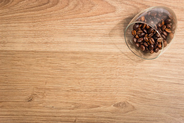 coffee beans in a glass on a wooden boards background