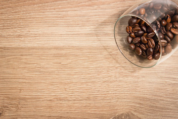 coffee beans in a glass closeup on a wooden boards background