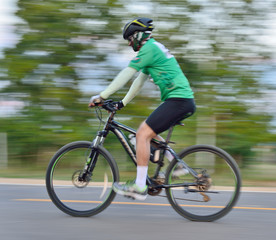 Obraz premium Riding a bike on a street motion blur