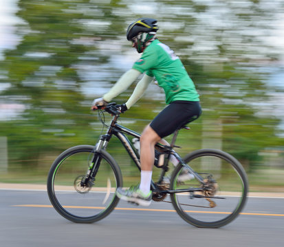 Riding a bike on a street  motion blur