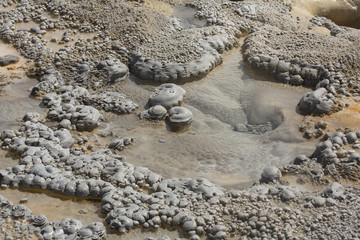 Gray mounds, like colonnades, along rim of hot spring, Yellowstone.