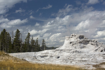 White limestone of Castle Geyser with deep blue sky, Yellowstone.