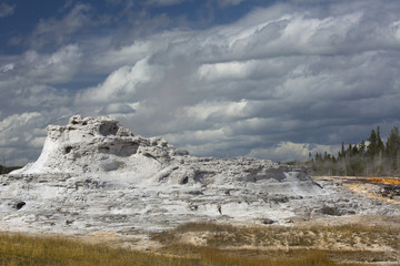 White limestone of Castle Geyser with deep blue sky, Yellowstone.