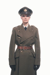 Powerful retro army woman wearing coat with belt and hat. Isolat