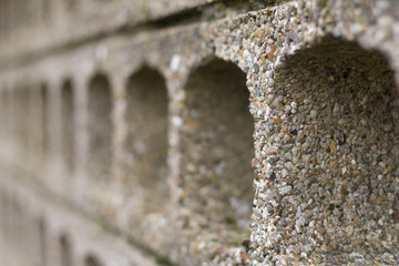 concrete wall with arched holes. artistic limited focus and blur. - 99980320