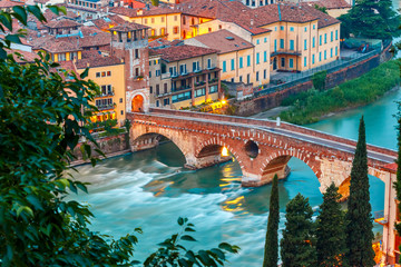 Ancient Roman bridge Ponte Pietra and the River Adige at evening, view from Piazzale Castel San...